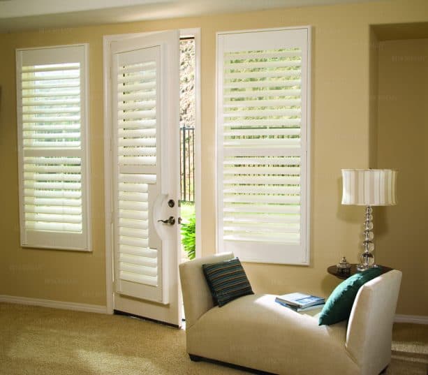 white plantation shutters covering a single French door
