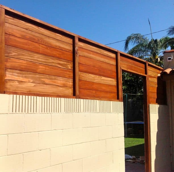 ivory cinder block walls with redwood fence combination