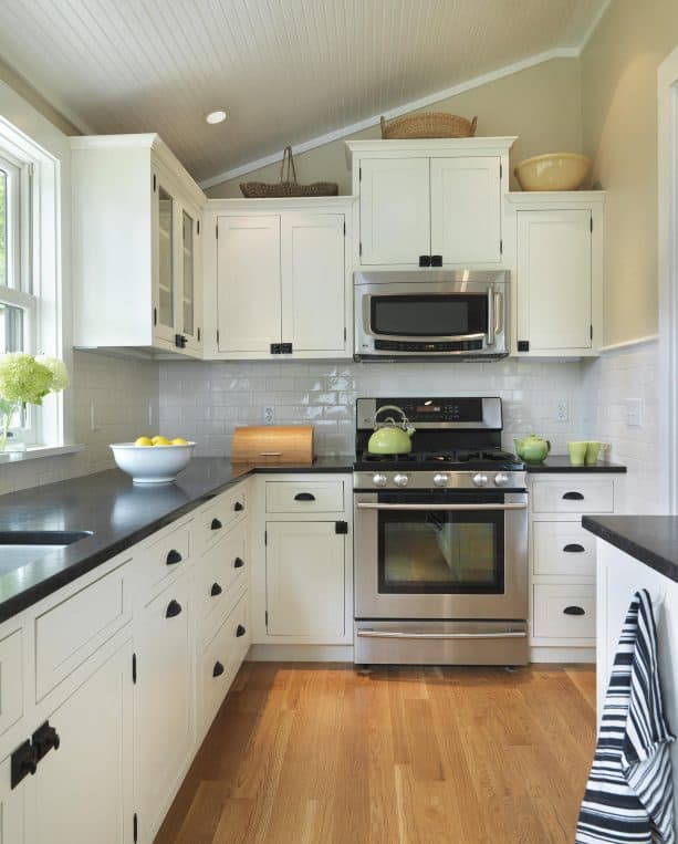 cream cabinets with honed black granite countertops with leather finish
