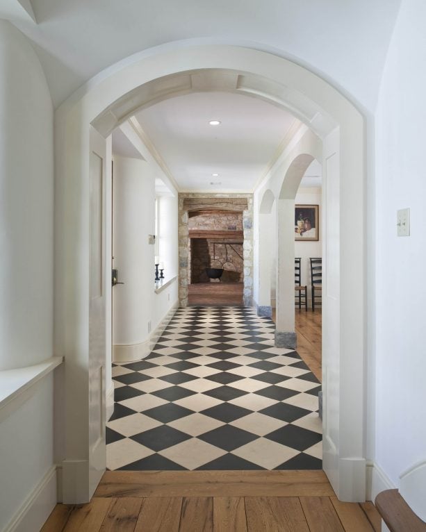 the combination between black and white checkered marble floor and hardwood