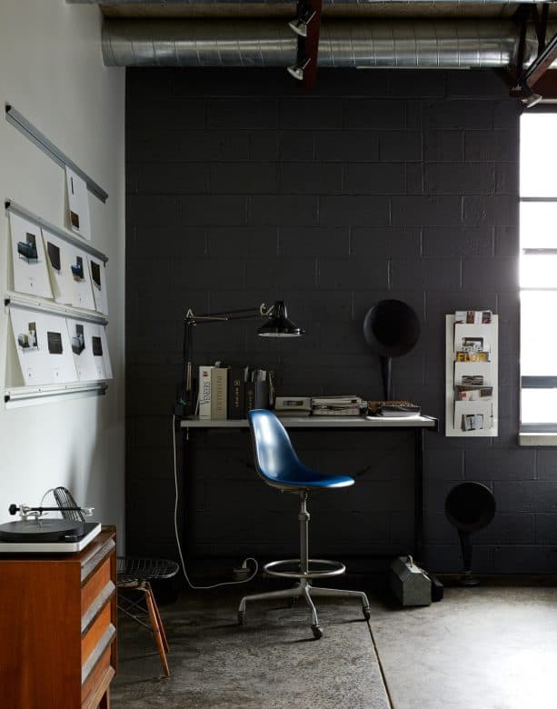 an industrial office nook with black cinder block wall