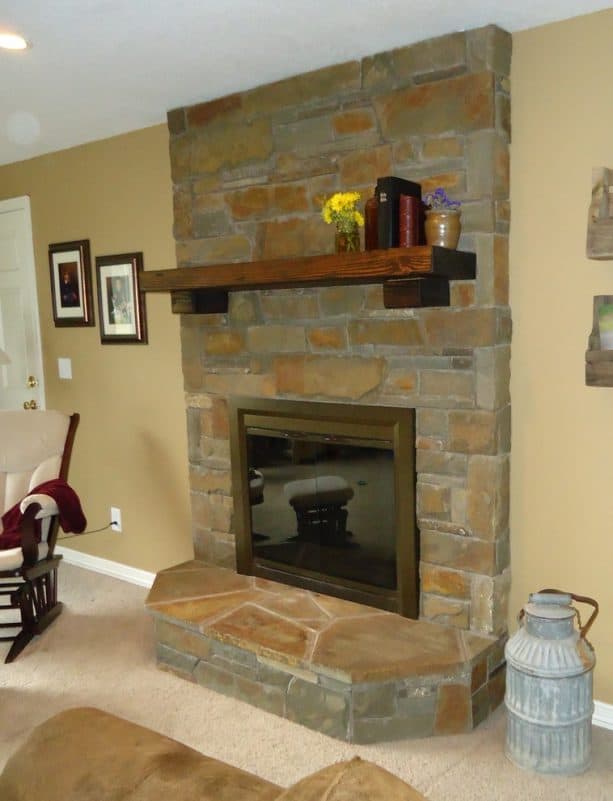 after makeover floor to ceiling natural stone fireplace with neutral wood toned mantel shelf