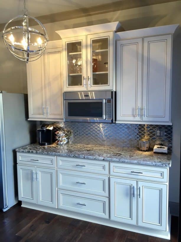 traditional kitchen with antique white cabinets and tubular metal bar pulls