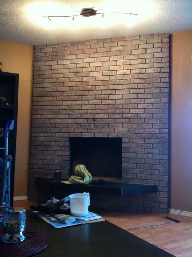 black standard modern fireplace with wall-size gray-washed brick fireplace mantel