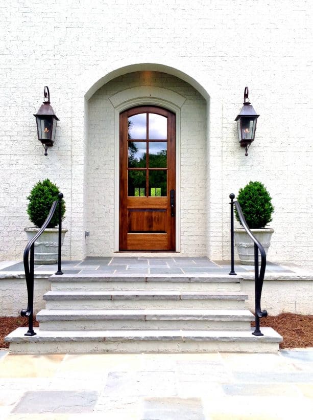 a mahogany door with antique brown stain and white trim