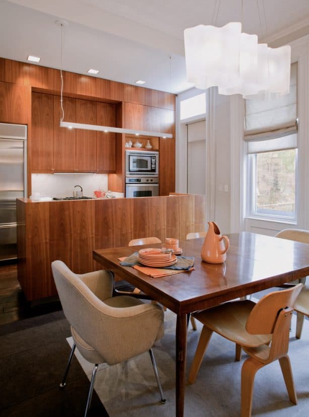 a free-standing style half wall from walnut in a contemporary kitchen and dining area