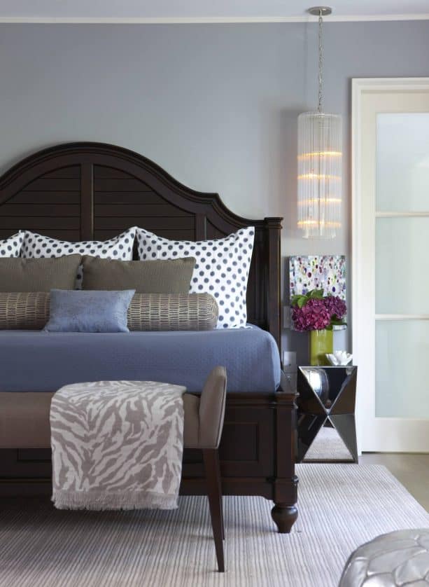 blue and grey bedroom with brown king size wooden bed
