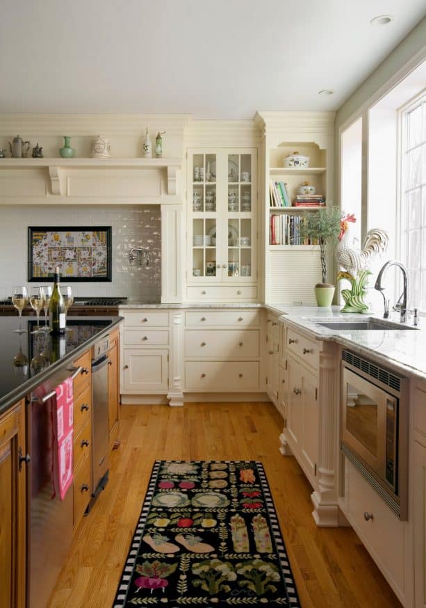 off-white cabinets with a built-in bookshelf at the corner