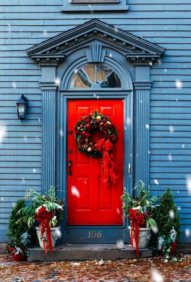 a stone blue house with candy red door