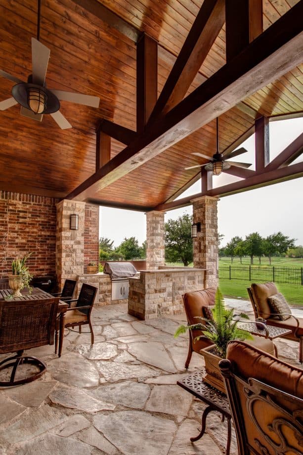 a traditional porch with stained pine tongue and groove ceiling