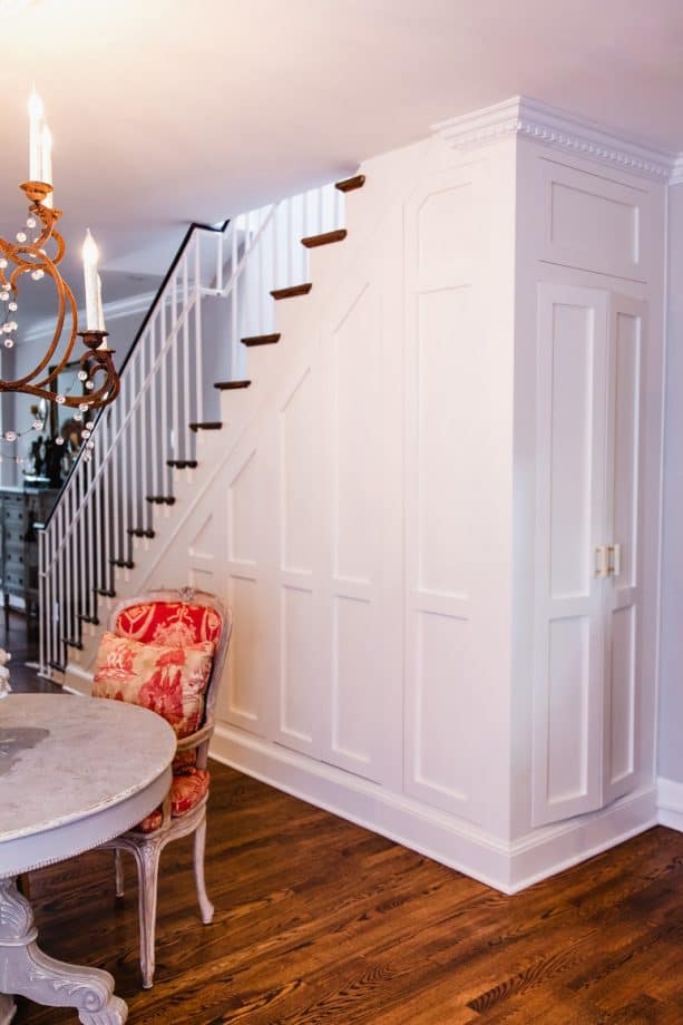 the laundry closet is hidden excellently under the stair