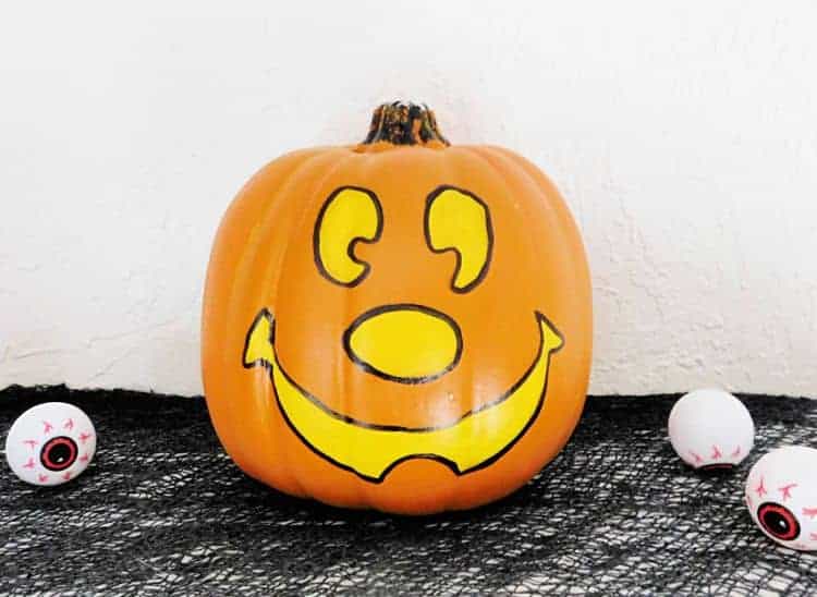 Mickey pumpkin with face painted on it
