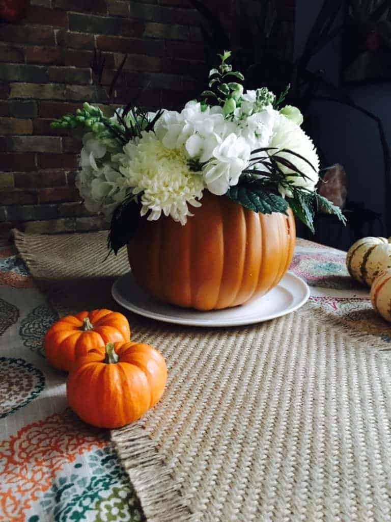 thanksgiving floral centerpiece. Pumpkin vase filled with flowers