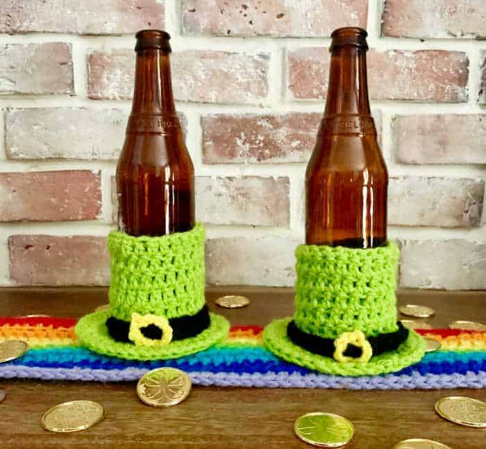 two beers inside the leprechaun cozy on table