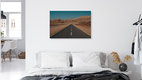 Mockup Expansive desert road under clear sky, conveying solitude and freedom.