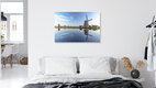 Mockup Photo of windmills in Holland, gentle water reflections and clear blue sky.