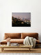 Mockup Photo art by Inflight Galerie: view of a city skyline at night with glowing lights.