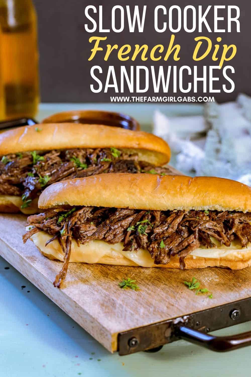 These flavorful Easy Crock Pot French Dip Sandwiches are a family favorite. Top them with provolone cheese and serve with a side of au jus. This Slow Cooker French Dip Sandwich recipe is perfect for a weeknight meal or to serve at a game day party or casual get together. This is an easy sandwich recipe that everyone will enjoy. #frenchdip #slowcookerrecipe #crockpotrecipe #slowcookerfrenchdip