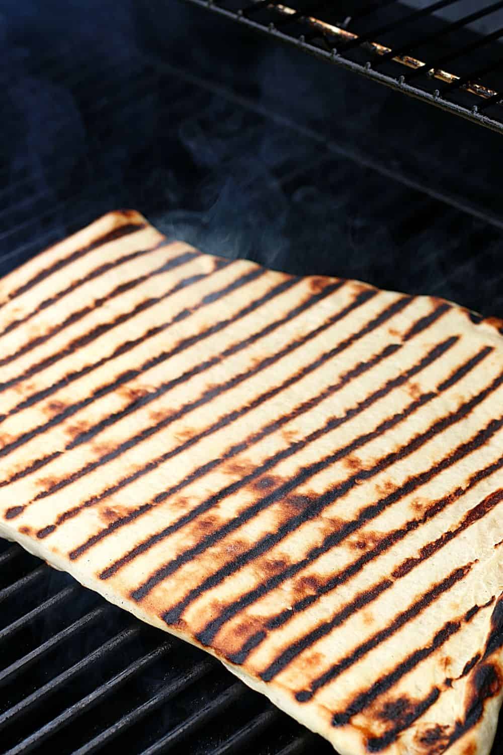 It's time to fire up the grill and turn a traditional pizza recipe into an easy and delicious Grilled Pizza. Here's How To Make the Perfect Grilled Pizza recipe.