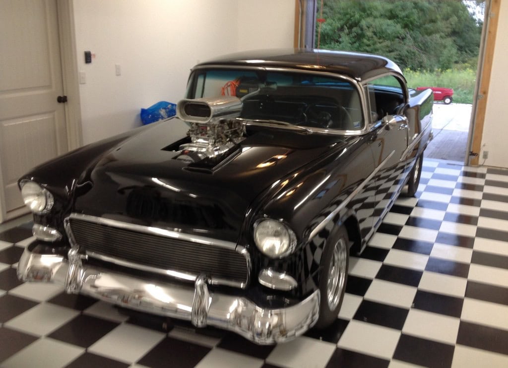 Classic car on checkerboard floor in garage