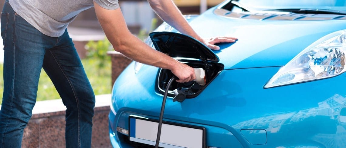 A person charging an electric car