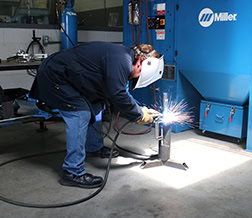 Man bending over welding that shows improper welding ergonomics