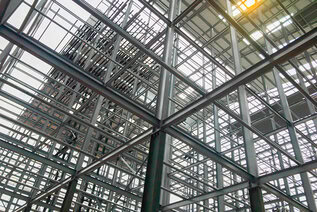 View of steel girders on a construction site from ground level
