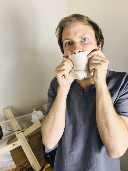 Paddy trying to blow air through a coffee filter to filter out coronavirus particles