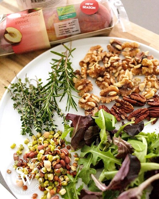 The raw ingredients for making the Maple Syrup Grilled Peach and Nut Salad. Including lentils, herbs and nuts.