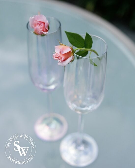 delicate roses balanced on champagne glasses for the prosecco cocktail with rose and elderflower