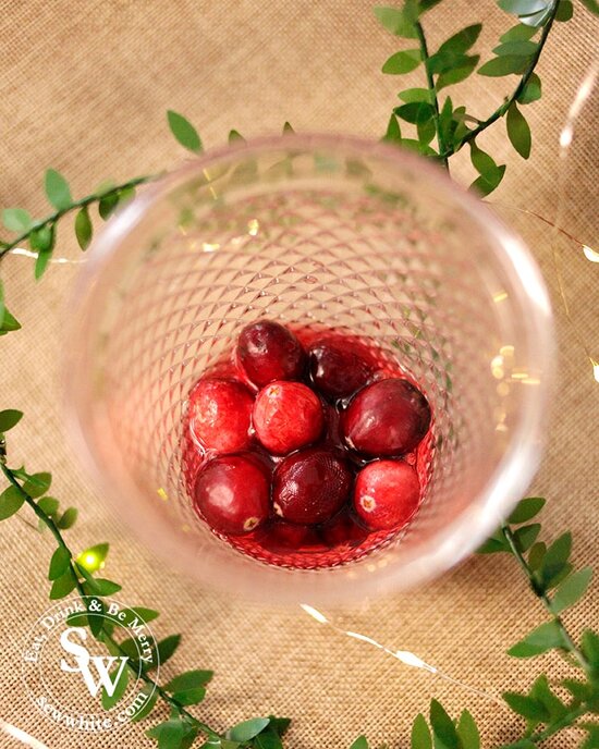 fresh cranberries in the bottom of a glass with cranberry liqueur