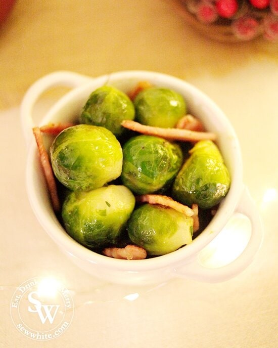 A close up of the Brussels Sprouts with Bacon in a petite Le Creuset casserole dish for Christmas dinner.
