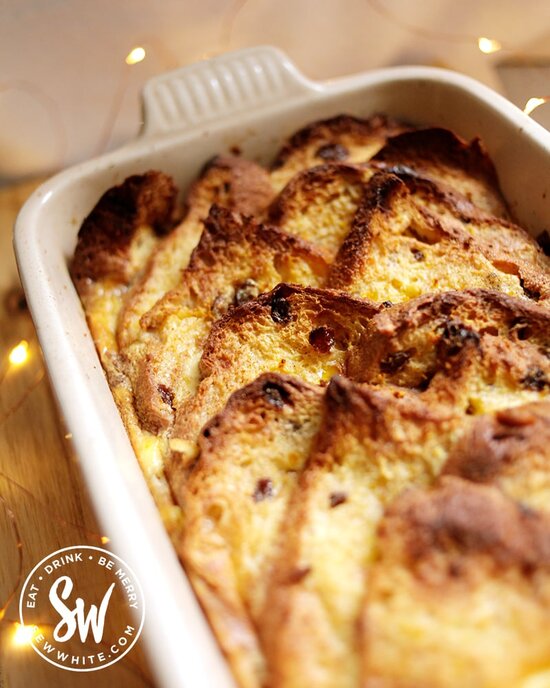 Panettone bread and butter pudding golden brown and straight from the oven. Thick slices of bread topped with orange zest and cooked in custard.
