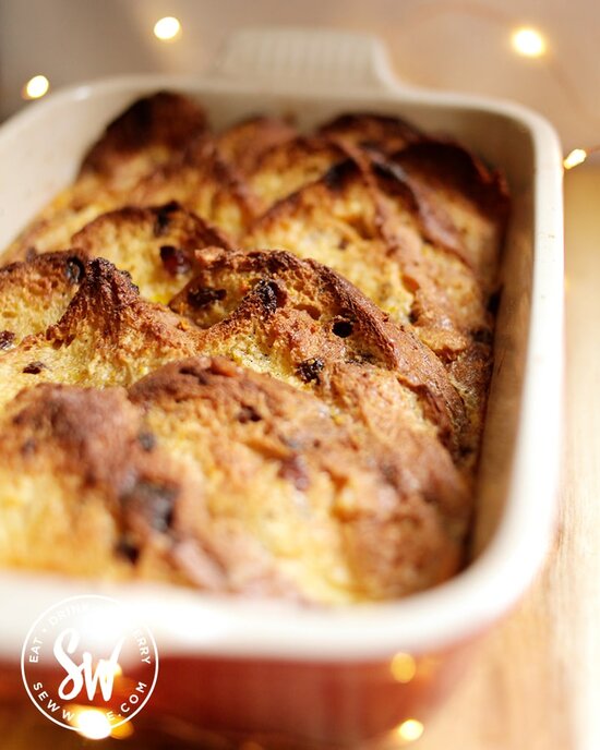 Golden brown toasted Panettone slices in an oven proof dish baked with custard for a Panettone bread and butter pudding.