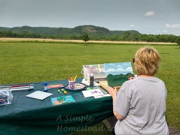 Colleen painting at the campground