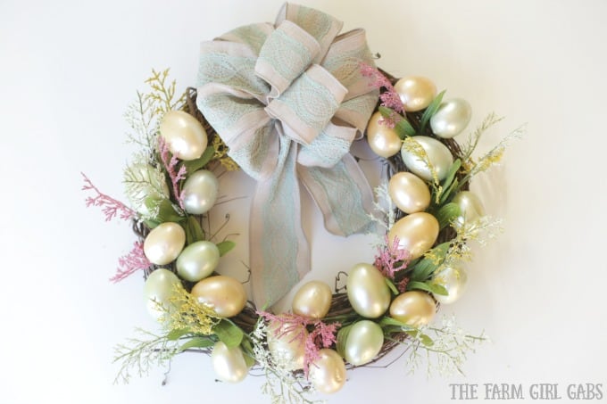 Brighten up your front door with this easy and welcoming DIY Spring Easter Egg Wreath. It's the perfect way to welcome spring. #SpringWreath #Easter #Wreath