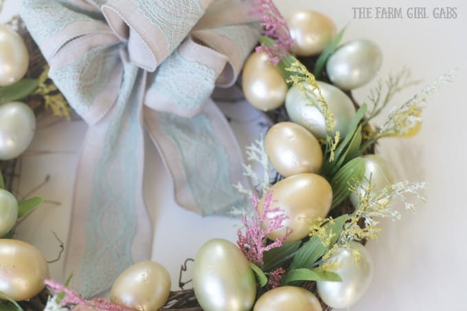 Brighten up your front door with this easy and welcoming DIY Spring Easter Egg Wreath. It's the perfect way to welcome spring. #SpringWreath #Easter #Wreath