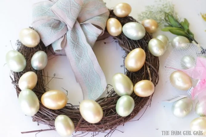 Brighten up your front door with this easy and welcoming DIY Spring Easter Egg Wreath. It's the perfect way to welcome spring. #SpringWreath #Easter #Wreath