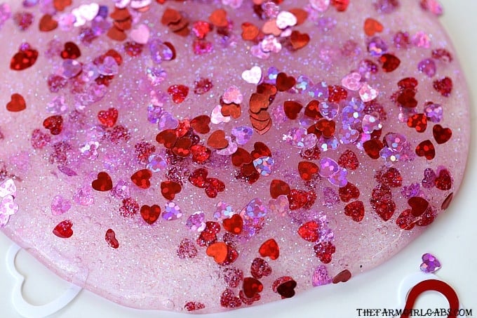 You and your kids will LOVE making this easy DIY Valentine's Day Slime project. This fun craft makes a great party favor too!