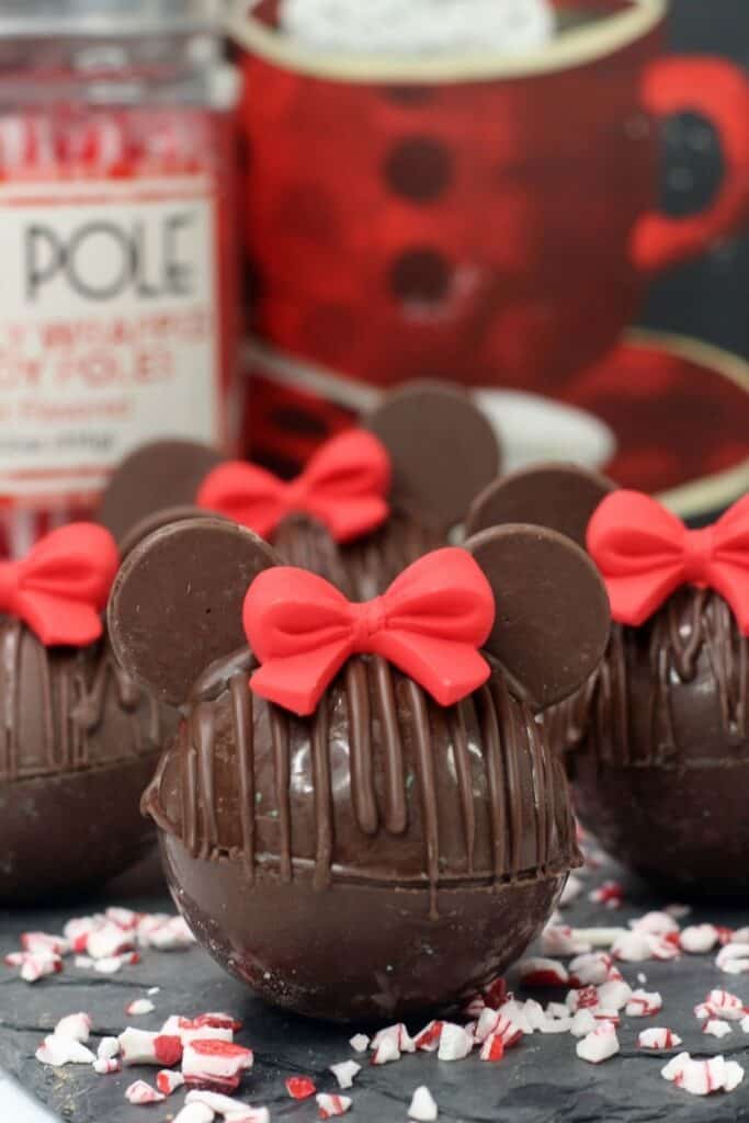 Create your own Disney hot chocolate bombs at home. These Minnie Mouse Hot Cocoa Bombs are the perfect way to warm up. Share some and enjoy some for the perfect warm-up. This Hot Chocolate Bombs Recipe is rich and filled with hot chocolate mix and marshmallows. Disney fans will love making this fun Disney recipe at home.