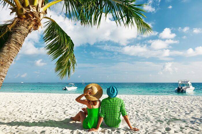 A couple on a beach enjoying a happy summer