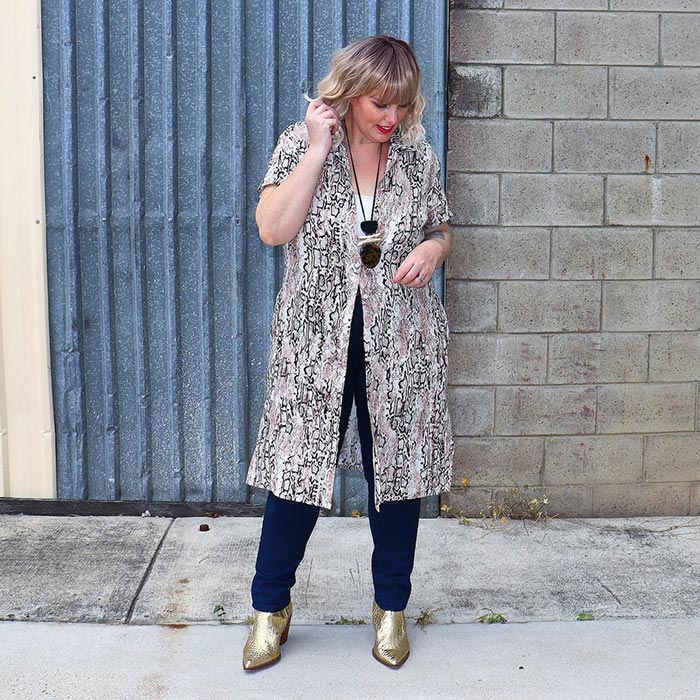 Mel wearing a printed topper, jeans and booties | 40plusstyle.com