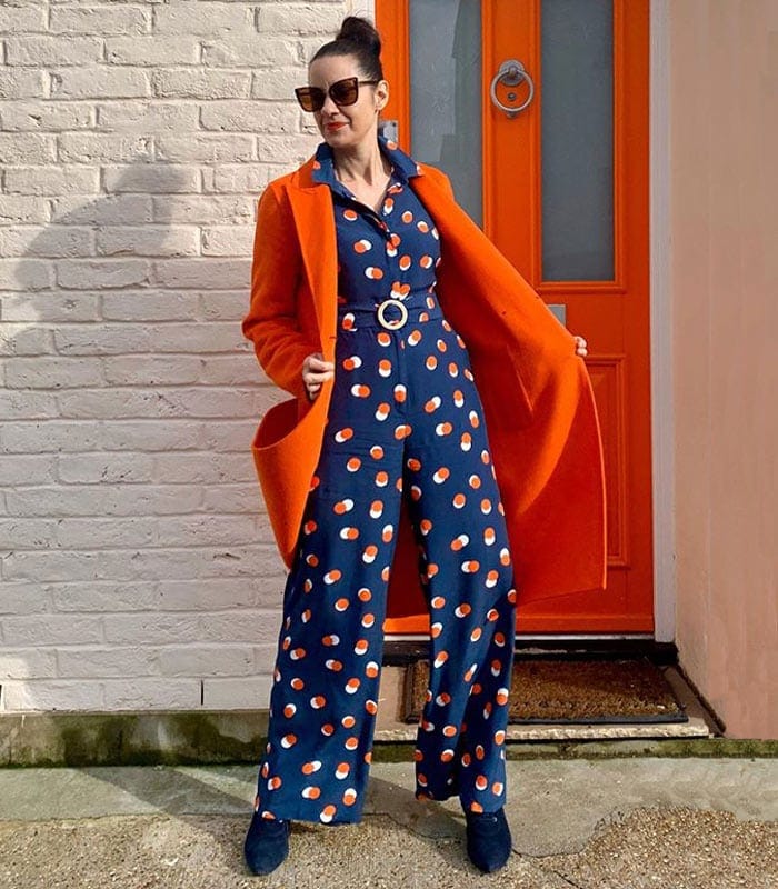 Katie wears a navy and orange outfit | 40plusstyle.com
