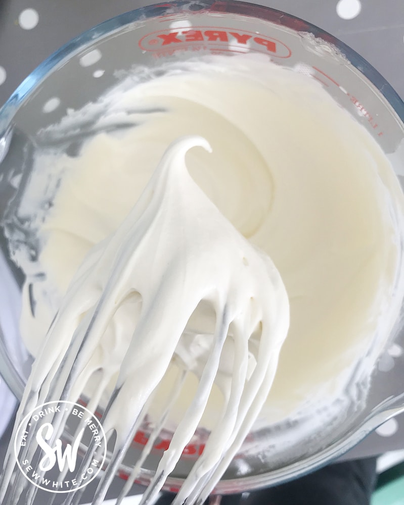 Whipping up double cream to make a cheesecake.