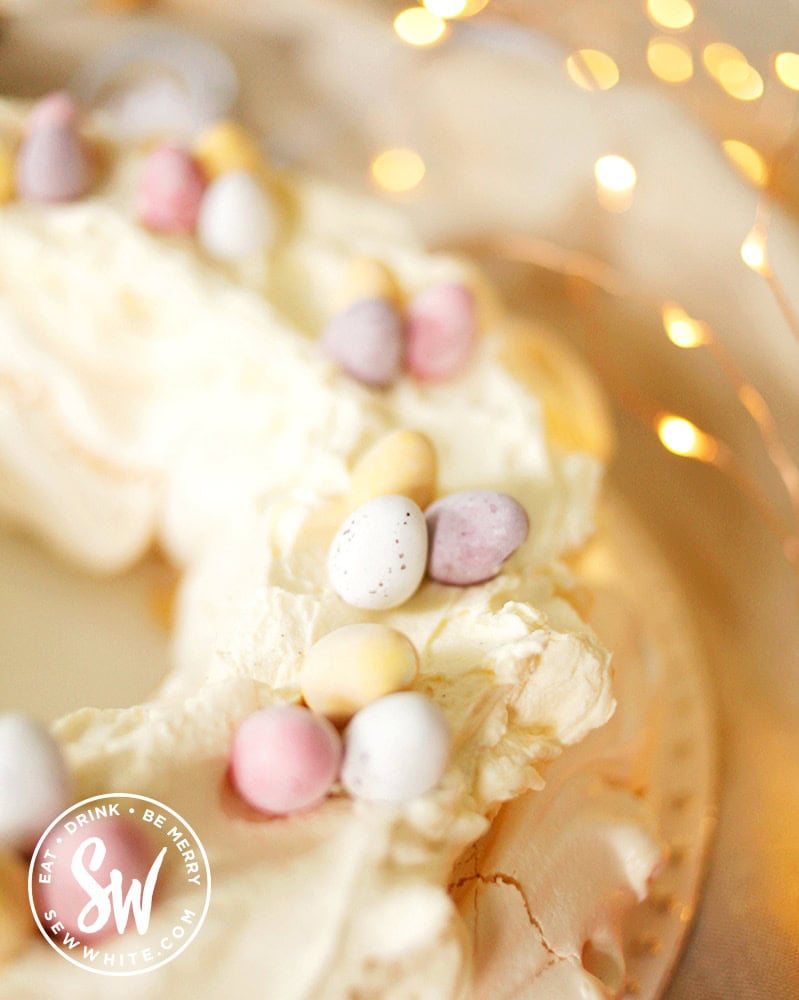 Close up of the Easter pavlova topped with pastel coloured mini egg chocolate eggs
