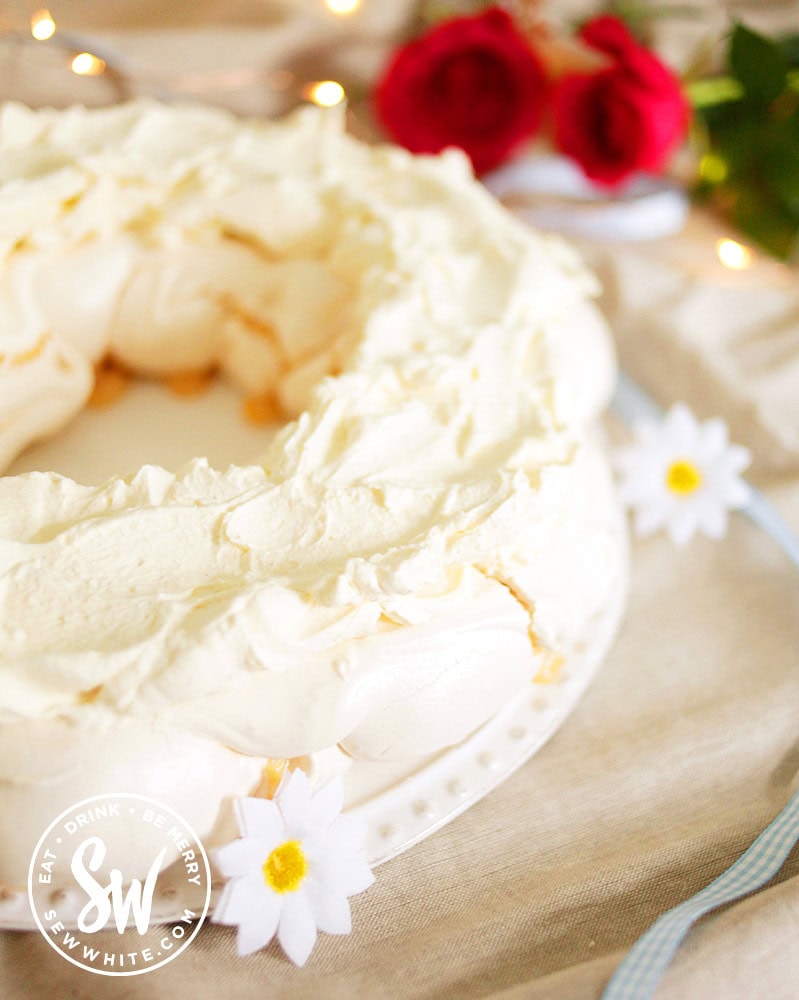 Pavlova base with cream topping ready to be decorated for the Easter meringue