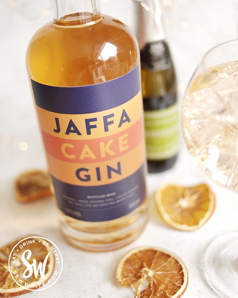 Jaffa Cake Gin bottle with a gin glass and prosecco bottle