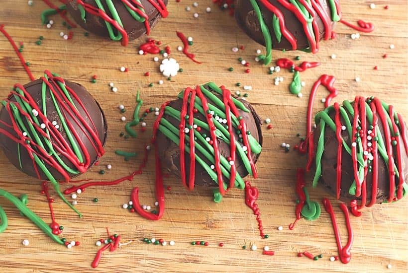 Ready for an indulgent treat? This Hot Chocolate Bombs Recipe is rich and filled with hot chocolate, marshmallow and sprinkle surprises inside. What is a hot chocolate bomb? A Hot cocoa bomb is a chocolate shell that is filled with hot cocoa, marshmallows and other hot chocolate add ins. Download the free Christmas printable gift bag toppers and give these as a Christmas food gift.