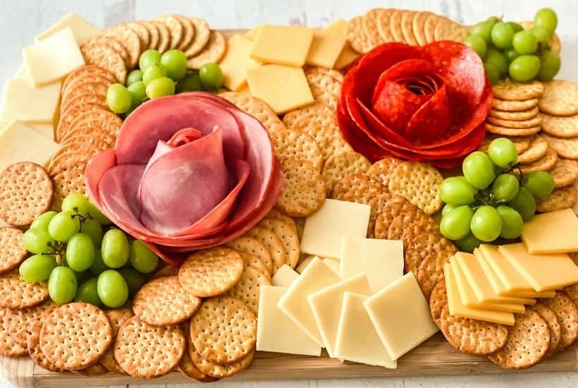 Dazzle your guests with this easy charcuterie board idea. Learn how to make a Charcuterie Board With Meat Flowers. It looks fancy but these meat flowers are easy to make. This is an easy party idea!