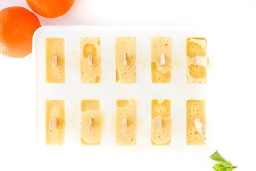 Orange Julius Popsicles are creamy, smooth, and full of orange flavor. If you love an orange creamsicle, you are going to love this variation of the classic frozen treat. This Copycat Orange Julius Pops Recipe is perfect for a hot summer day. Try this homemade orange creamsicle recipe today.
